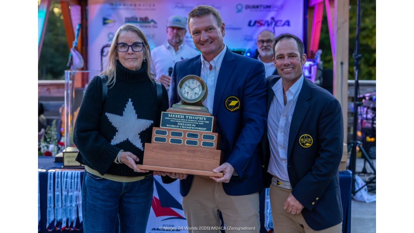 Sandy Askew by Flying Jenny (USA 869) receives the Meier Trophy for the highest-finishing female helmsperson from Little Traverse Yacht Club Commodore Dunne Saal and Vice Commodore George Peet after guiding Flying Jenny to tenth overall - Melges 24 World Championship 2026 - Harbor Springs, MI, USA 