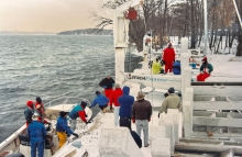 This photo shows the Melges 24, hull no. 1, being launched for the first time on Lake Geneva in the snow in December 1992